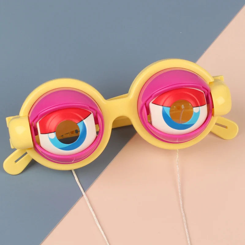 A pair of novelty funny glasses with bright yellow frames and pink lenses resting on a light background.