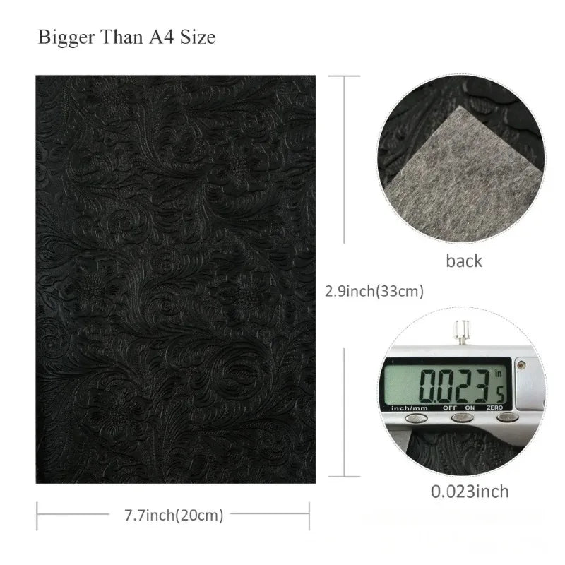 Black vintage floral textured faux leather fabric shown with a measurement scale and a back view.
