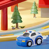 A blue and white race car toy is shown on a track with green trees in the background.