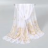 White chiffon scarf with gold shimmer detailing draped over a hanger