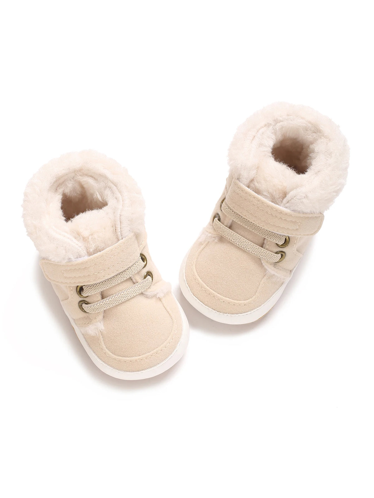 A pair of beige faux fur baby winter snow boots for toddlers with light tan fabric and white soles.