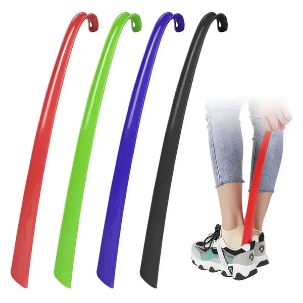 A set of extra-long plastic shoehorns in red, green, and purple are shown next to a person's legs.