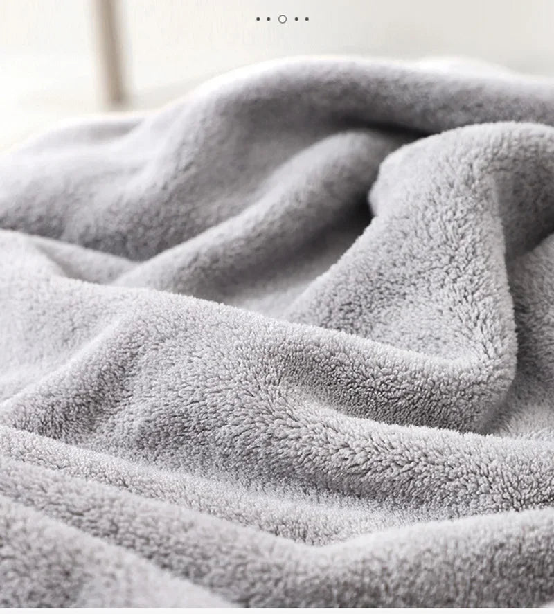 A soft gray animal-themed hooded baby bath towel draped and folded