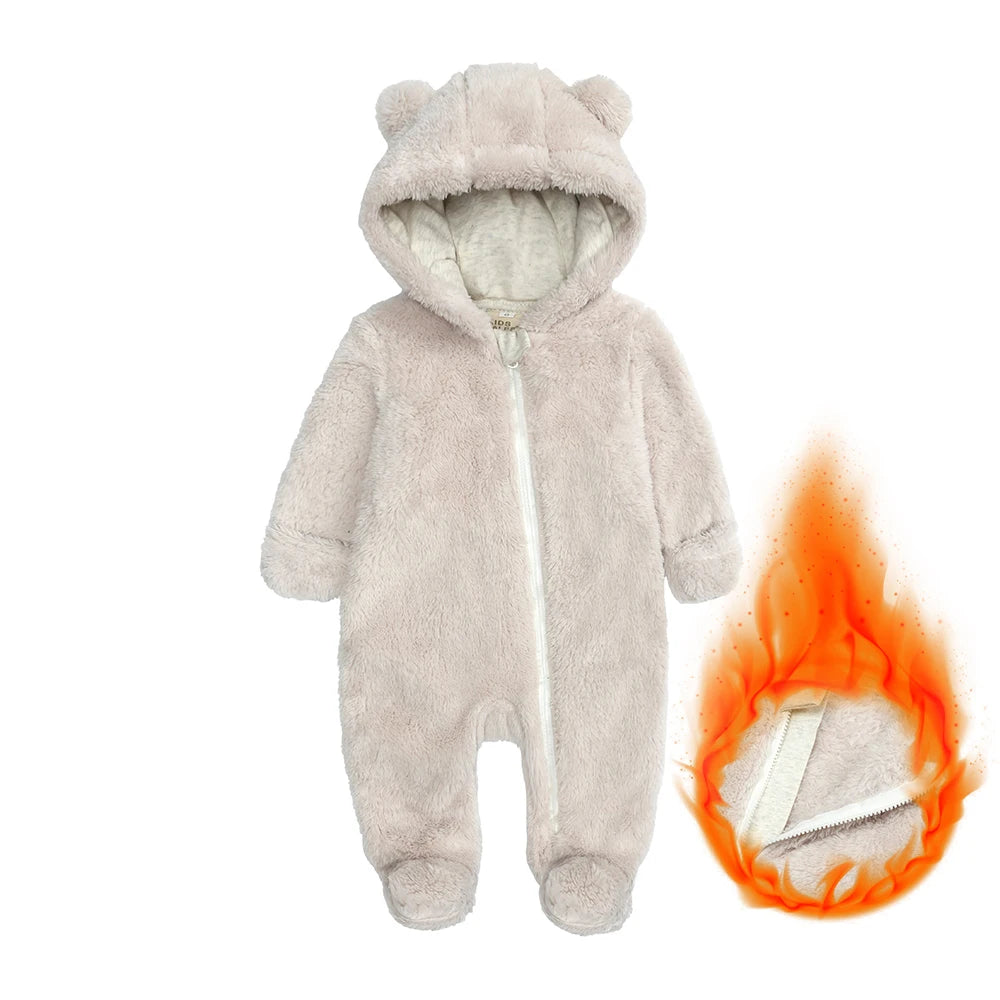 A light gray baby fleece hooded romper with a zipper, shown next to a flame.
