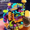 A child is playing with a multi-layered track adventure rolling ball toy featuring colorful plastic components and gears.