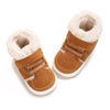 A pair of brown suede baby winter snow boots with fluffy cream-colored shearling lining.