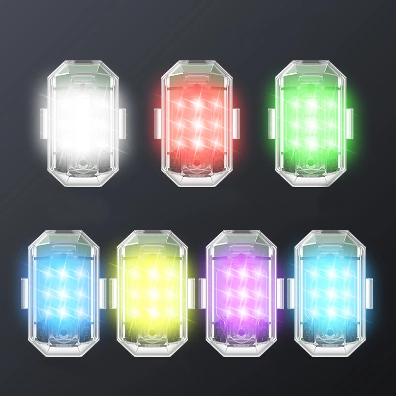 A set of five wireless LED strobe lights displayed in various colors including white, red, green, blue, and purple.