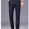Navy blue men's stretch straight-leg trousers worn by a man in a smart casual office setting.