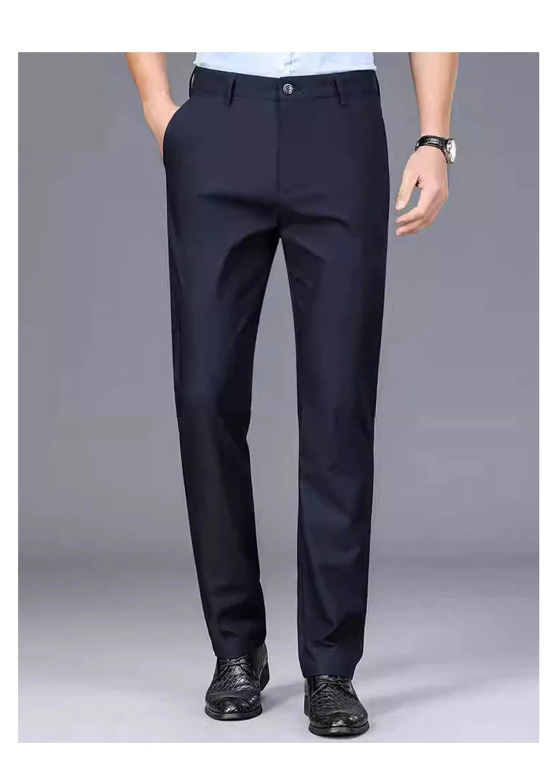 Navy blue men's stretch straight-leg trousers worn by a man in a smart casual office setting.