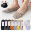 A pack of five men's no-show socks with silicone grip in various colors displayed on a foot.