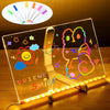 An LED glowing message board displays colorful drawings and text on a clear surface.