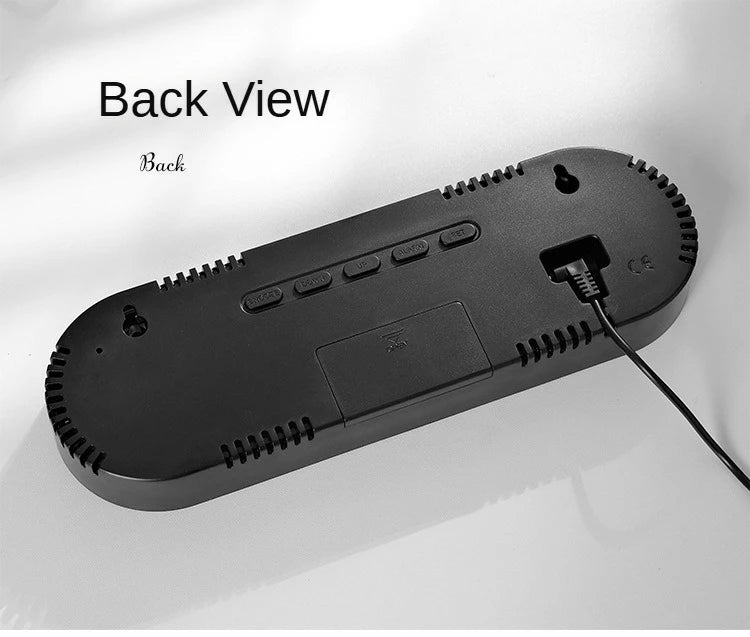 Back view of a black digital wall clock showing controls and a power port.
