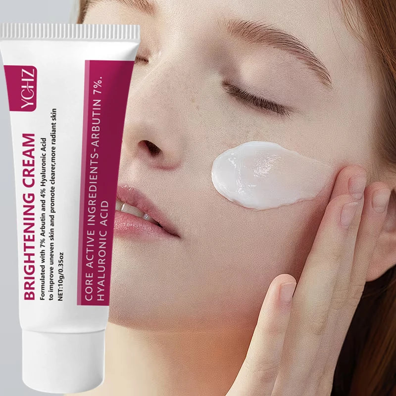 A cosmetic tube of brightening cream is shown being applied to a woman's face.