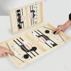 Jeu de palet en bois avec des palets noirs et blancs et un marqueur de vainqueur sur une table.