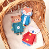 Three wooden felt animals, a fox, a bear, and a panda, are displayed inside a woven basket.