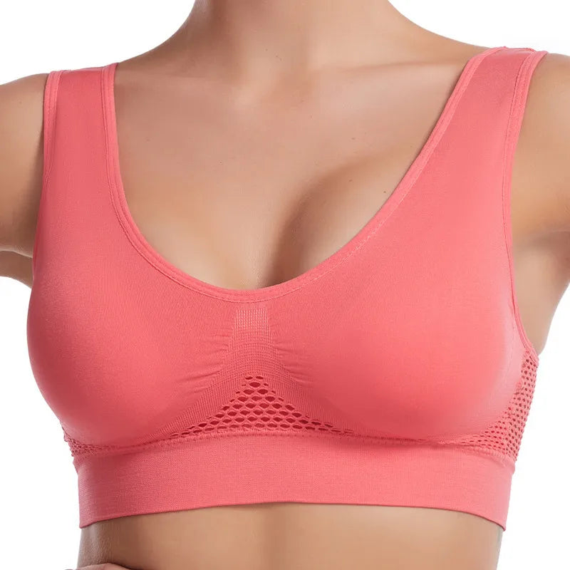 A close-up of a coral pink breathable sports bra for plus size women.