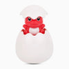 A white bath toy featuring a red frog and penguin head emerging from an egg-shaped body.