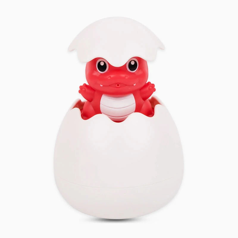 A white bath toy featuring a red frog and penguin head emerging from an egg-shaped body.