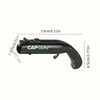 Black vintage cap gun style bottle opener with a grip and lever mechanism.