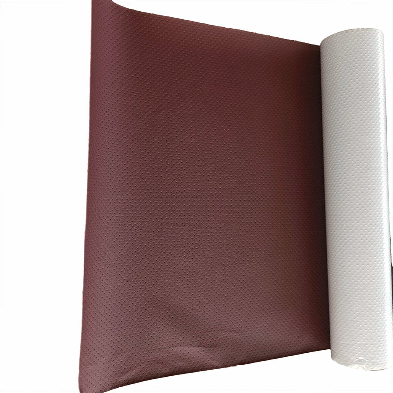 A rectangular brown leather repair patch is shown next to a roll of white self-adhesive material.