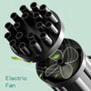 A black electric fan is shown in a close-up view against a light green background.