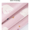 Pink cotton fabric featuring white floral patterns, folded to show texture and print detail.