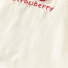 White kids summer pinafore dress featuring a strawberry and bunny print detail.