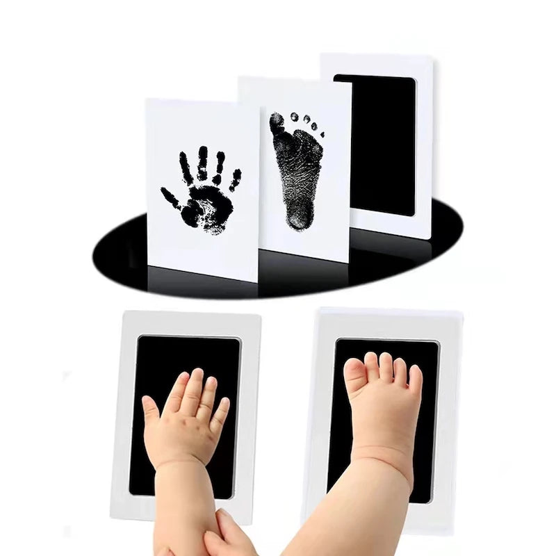 A set of inkless baby handprint and footprint keepsakes, including cards and molds for capturing baby prints.