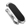 A silver magnetic phone mount with a black rotating surface for a car dashboard.