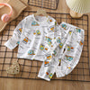 White kids cotton pajama set featuring a repeating pattern of yellow and blue construction vehicles