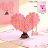 Pink 3D pop-up love tree card with a heart silhouette on a pink background.