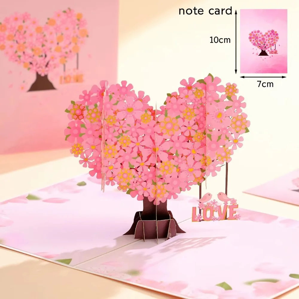 Pink 3D pop-up love tree card with a heart silhouette on a pink background.