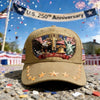 A khaki baseball cap featuring a patriotic graphic design with an eagle, cross, and liberty statue, set against a blurred out