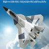 A white and gray SU-35 remote control fighter plane model flying against a blue sky background.