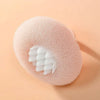 A pink bath sponge with a white, textured suction cup insert is shown on a light background.