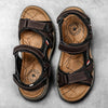 Pair of brown men's genuine leather air cushion sandals with black straps and wooden-look soles.