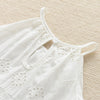 White cotton suspenders dress for a toddler girl shown flat lay