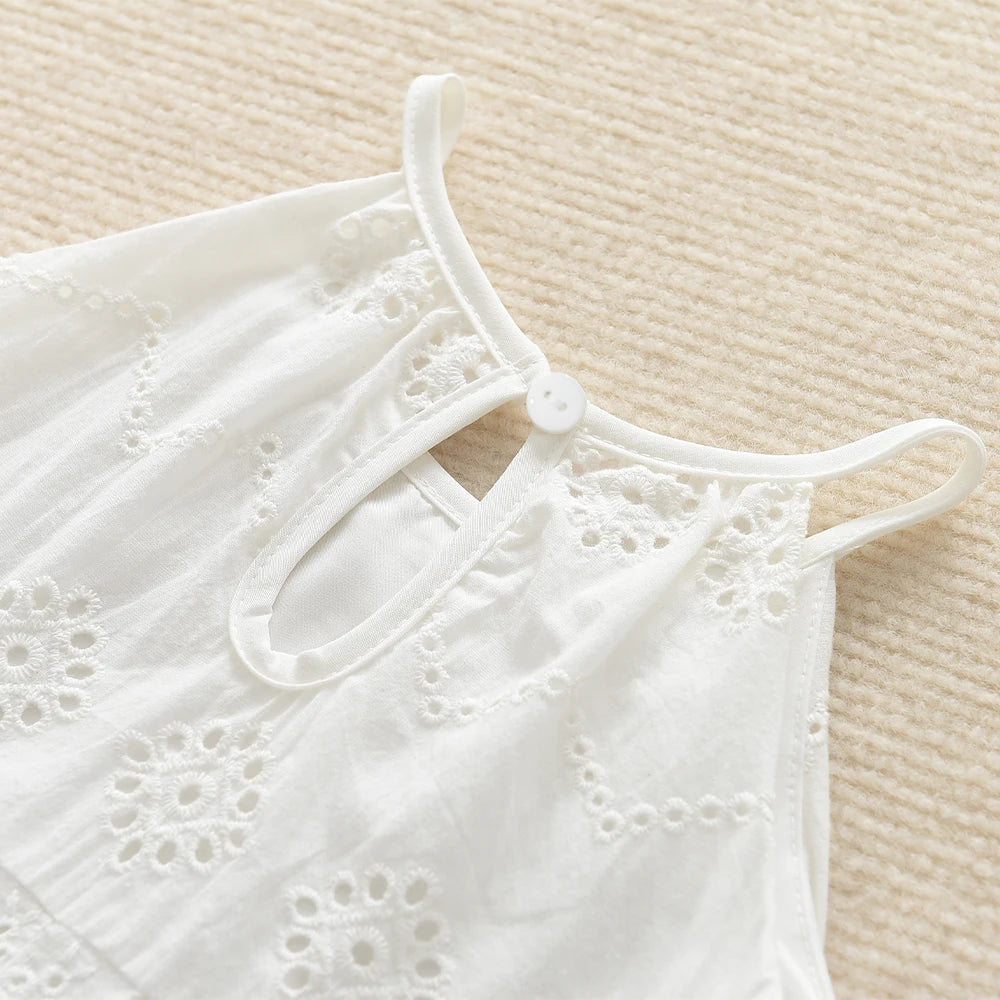 White cotton suspenders dress for a toddler girl shown flat lay