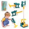 A child is playing with a green toy vacuum cleaner and its accessories, including a handheld unit and a floor attachment.