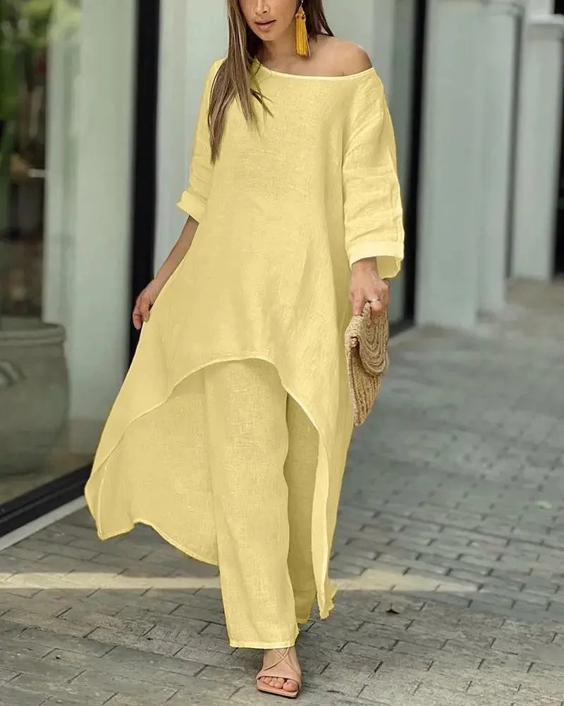 Kvinne modellerer gult bomull-lin loungesett med off-shoulder topp og vide bukser.