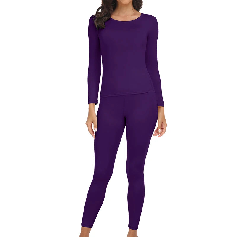 A woman wearing a long-sleeved purple thermal top and matching leggings.