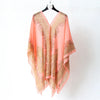 A sheer peach chiffon scarf with gold shimmer embroidery displayed on a hanger.