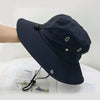 A black men's UV protection wide brim bucket hat is shown resting on a white surface.