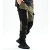 Men's waterproof insulated fleece pants in olive green and black fabric shown on a person's leg.