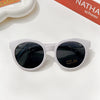 White sunglasses with dark lenses and a durable frame resting on a white surface.
