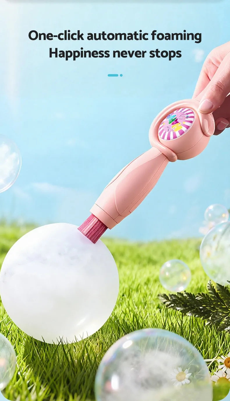 A hand is using a pink foam wand to create a large bubble on green grass.