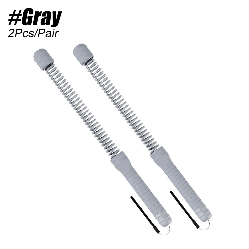 A pair of gray, coiled resistance bands or springs for home workouts.
