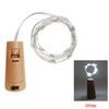 A bundle of white LED fairy lights is shown coiled around a cork bottle, ready for decoration.