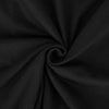 A dark gray or black fabric is tightly rolled into a ball.