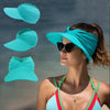 A woman wearing a turquoise UV-protective beach hat with a breathable hollow top and sunglasses.